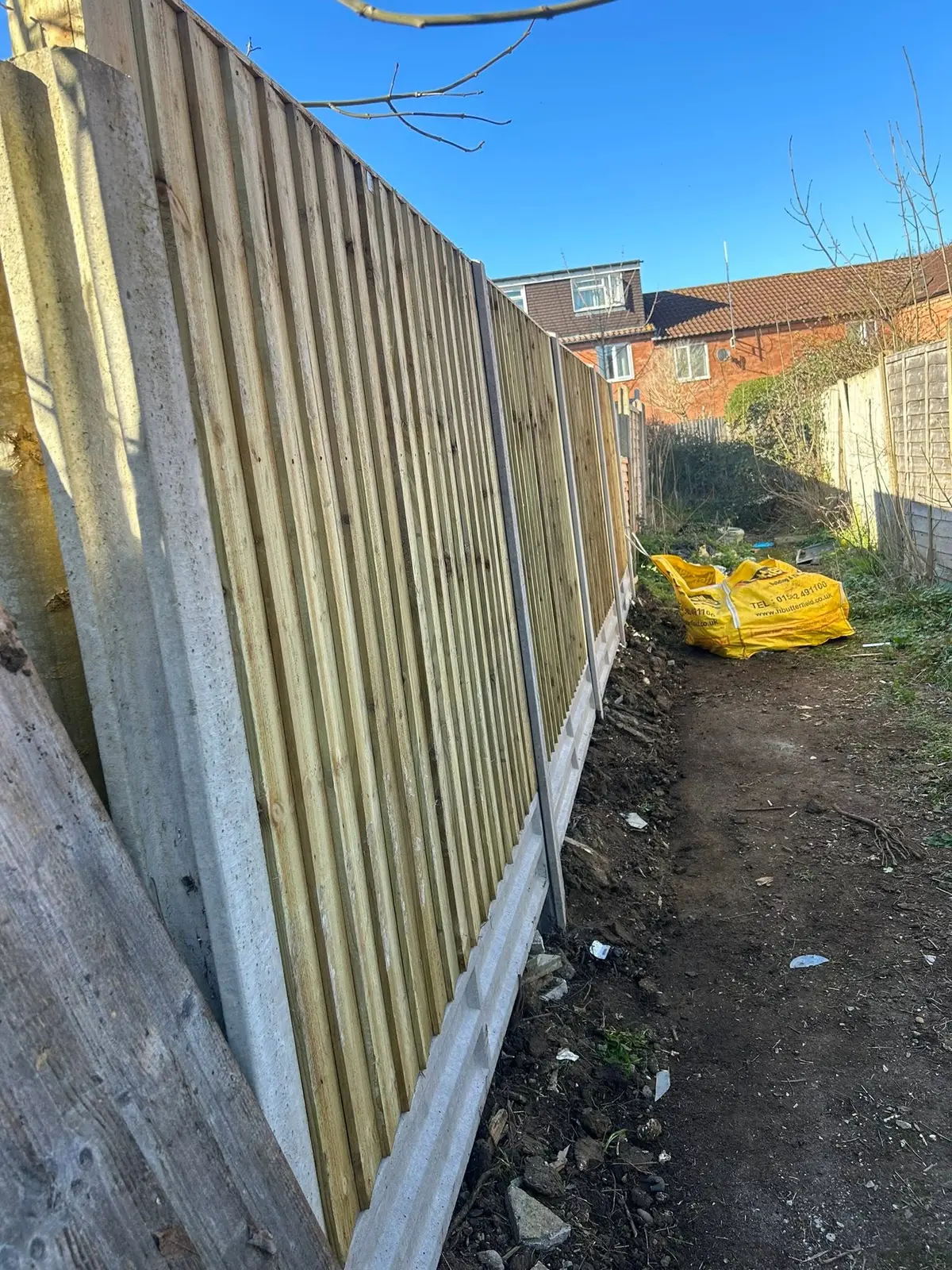 New feather-edge fence panels along a garden boundary