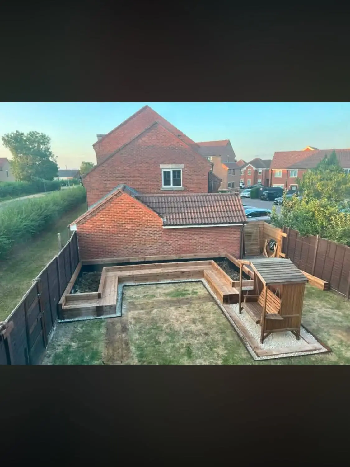 Full garden rebuild with retaining beds, lawn and swing seat, aerial view